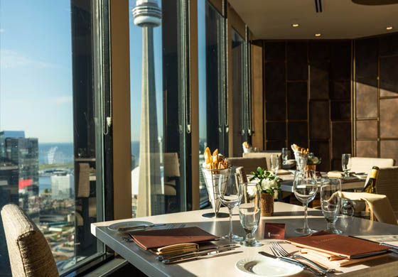 Table at Stratus Restaurant, with view of CN Tower in the background