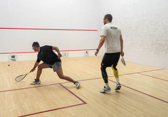 Two men playing squash at the Toronto Athletic Club as part of the Goodfellow Classic squash tournament