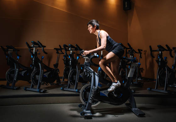 Fit woman on a stationary bike in the Cycling studio with Stages bikes at the Toronto Athletic Club