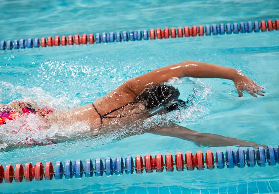 Fit woman swimming the front crawl in the penthouse pool at the Toronto Athletic Club