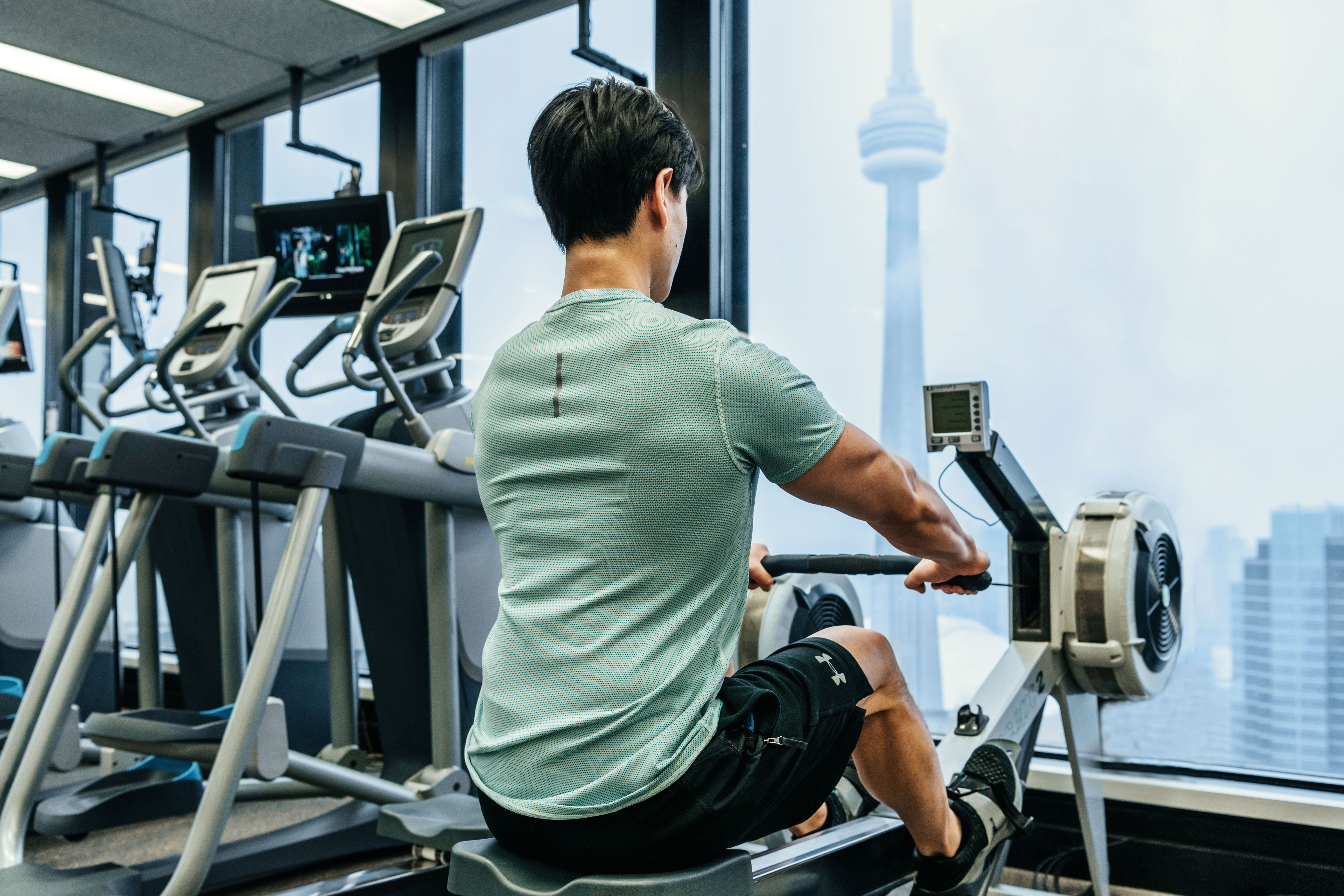 Male in the Strength Lab at the Toronto Athletic Club using the ski erg machine